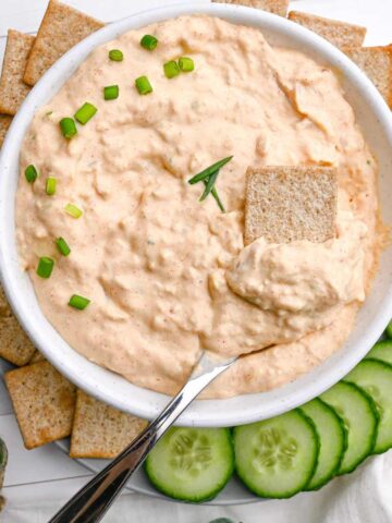 baked clam dip with crackers and cucumbers