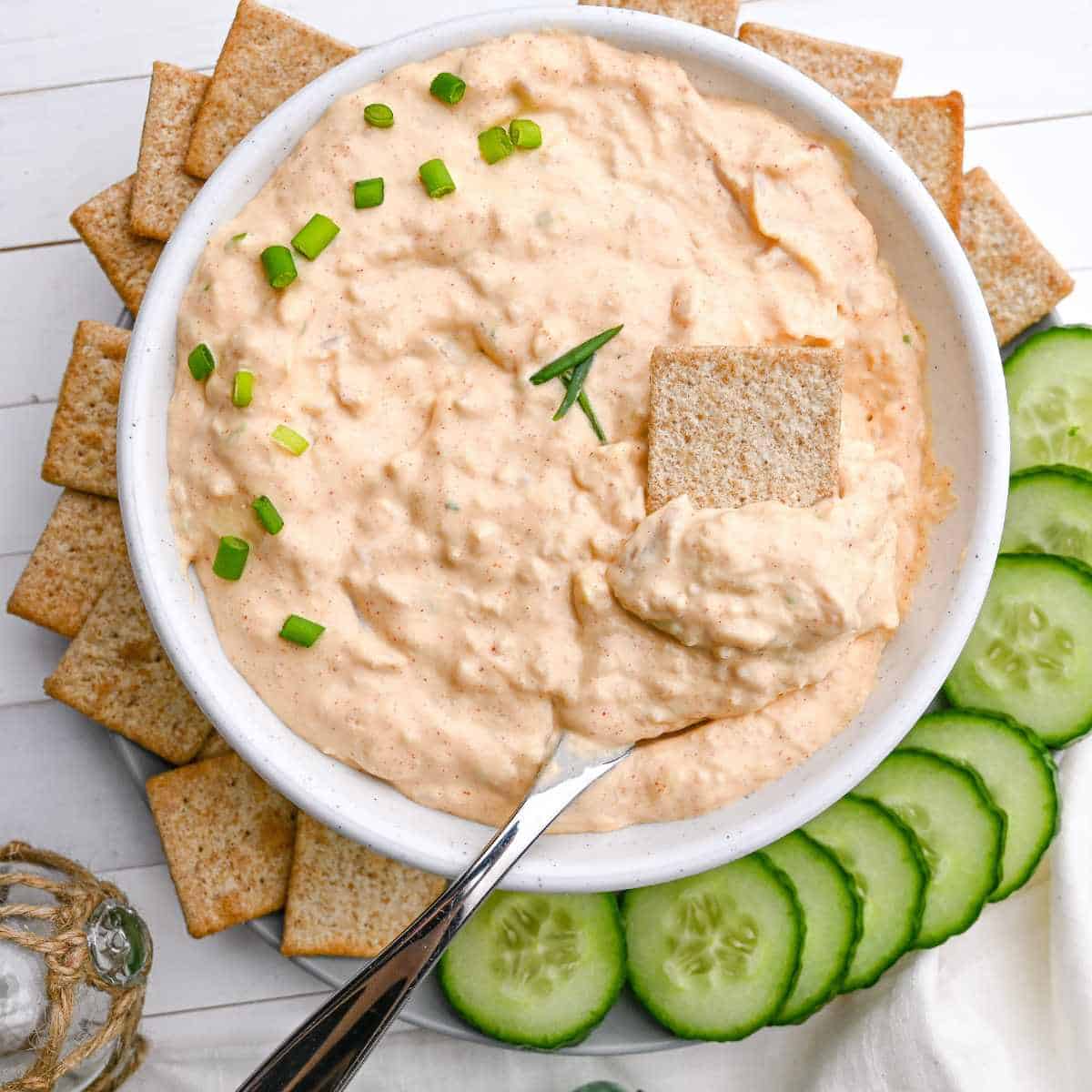 baked clam dip with crackers and cucumbers