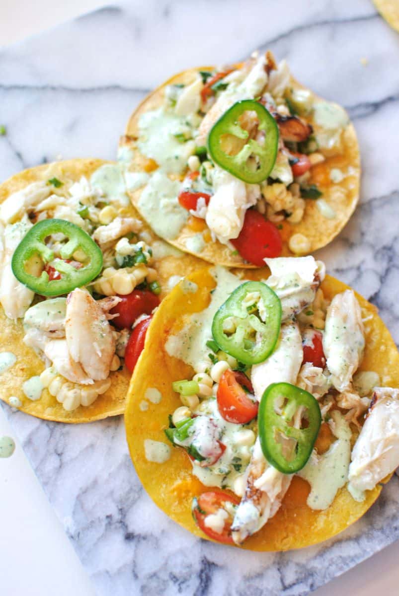 dungeness crab tacos with cilantro lime dressing and cold salsa topped with fresh jalapenos