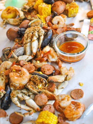 seafood boil recipe with butter sauce on the table