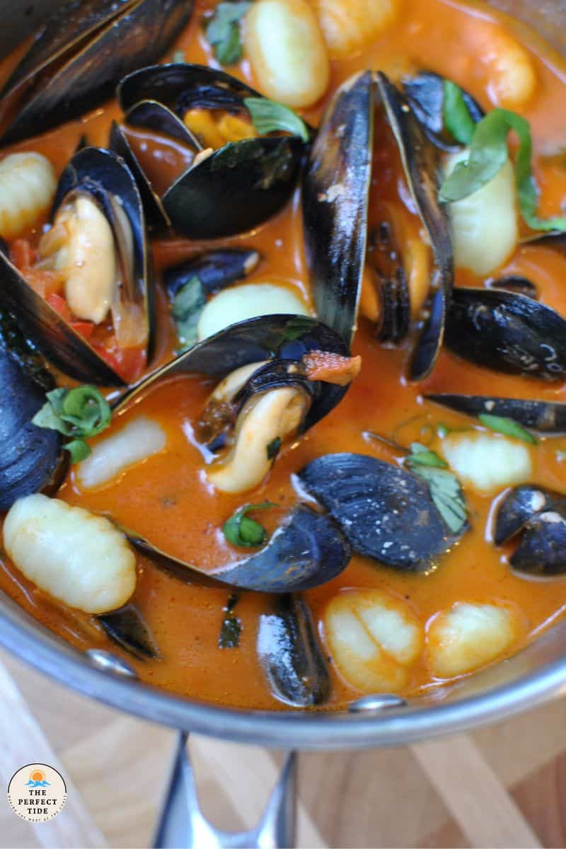 mussel soup italian style with gnocchi roasted red pepper sauce and basil