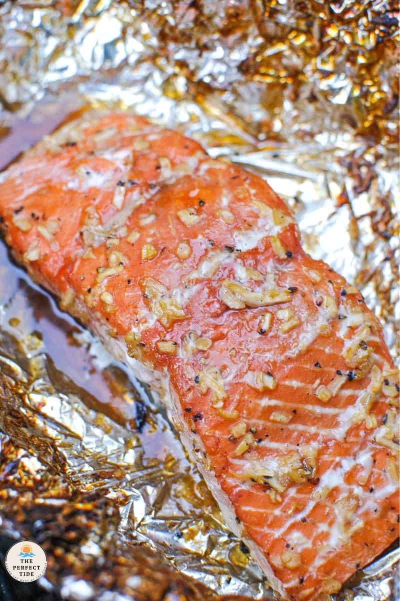 salmon fillet on foil with bourbon brown sugar and chopped onion glaze