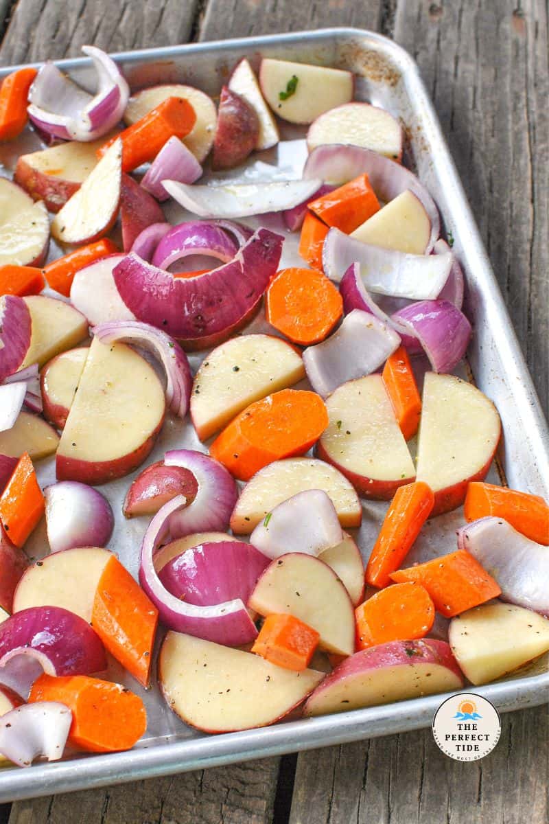 root veggies on a baking sheet with chimichurri sauce 