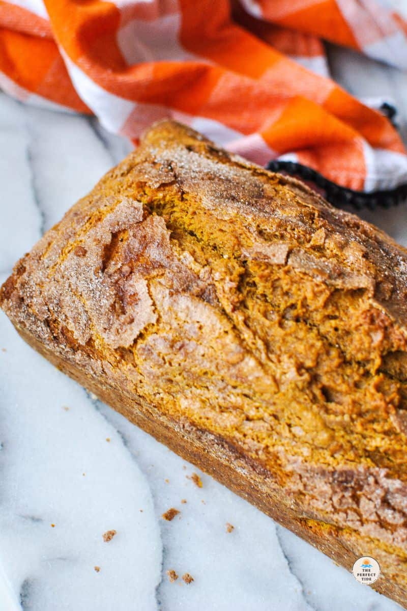 pumpkin bread recipe pumpkin bread loaf next to orange towel