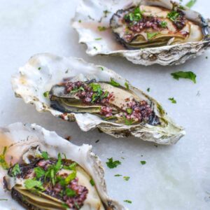 oysters cooked in air fryer with vinaigrette topping and garnished with parsley