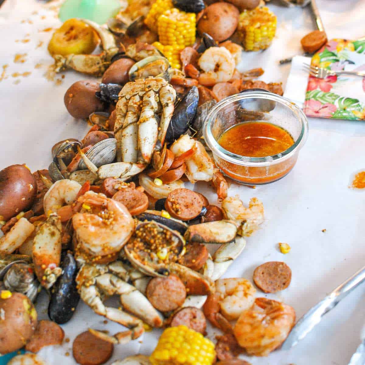 table of seafood boil with seafood boil sauce crab prawns mussels clams
