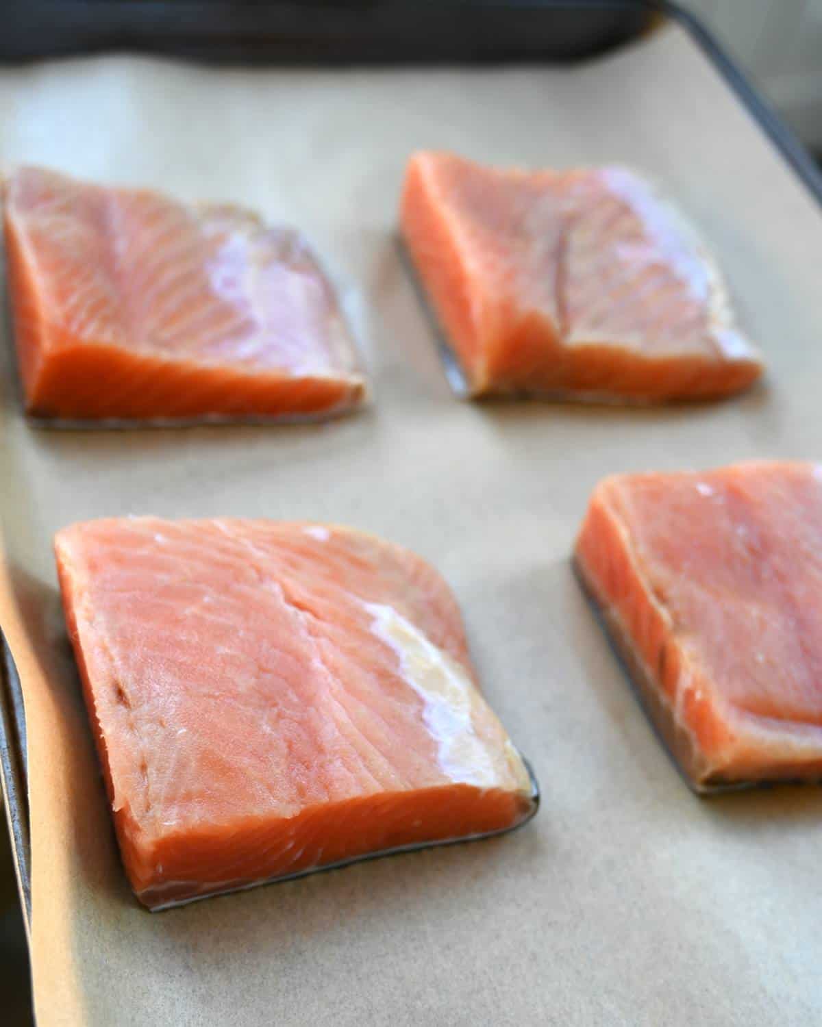 4 salmon fillets on parchment paper lined sheet pan step 1 how to make salmon furikake 