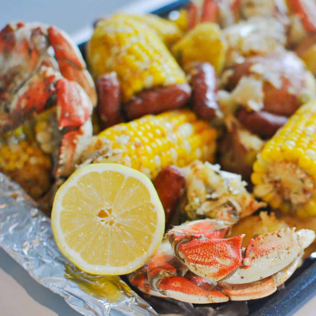 dungeness crab boil with corn sausage potato and lemon