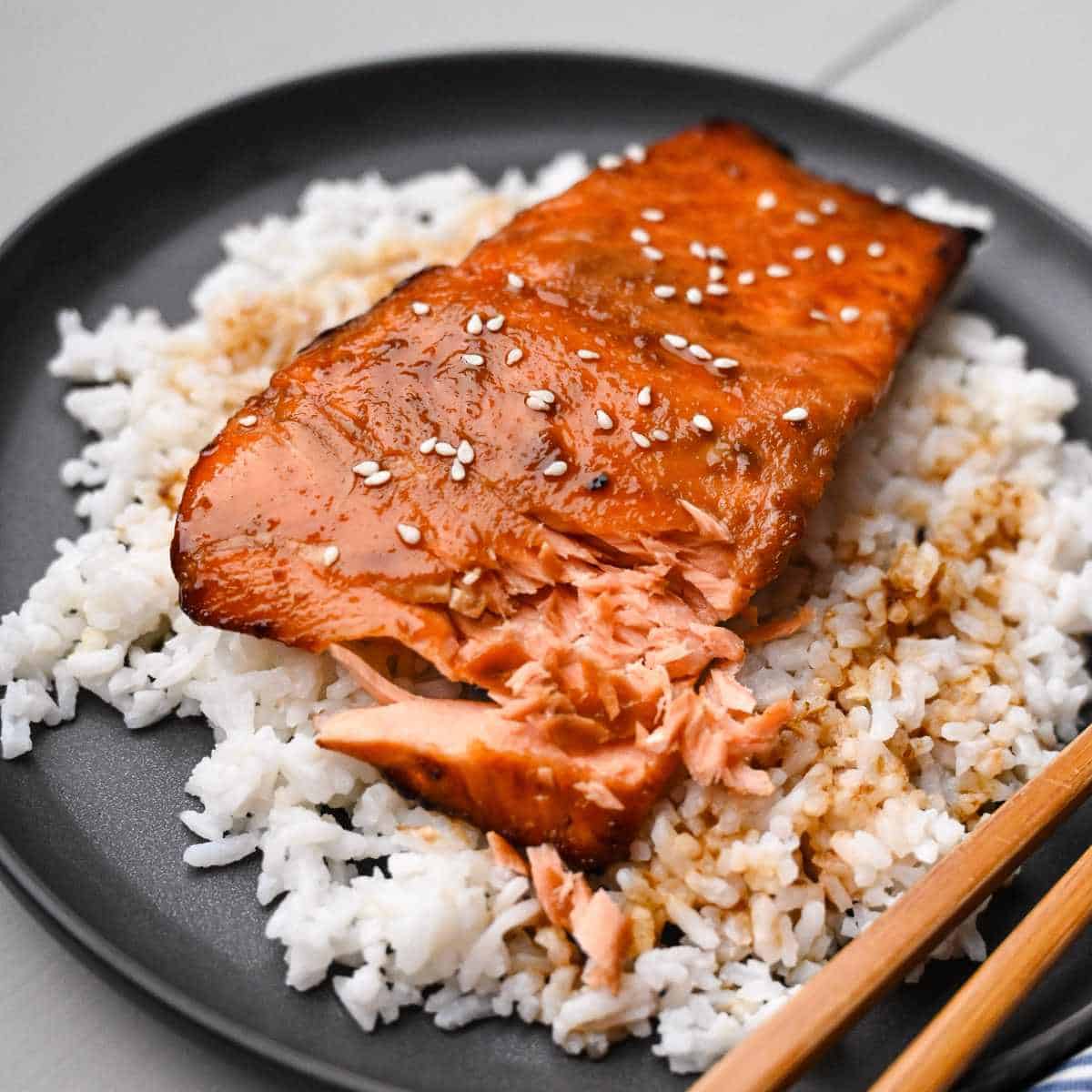 air fryer teriyaki salmon with sesame seeds on a bed of rice