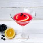blueberry lemon drop martini with lemon and blueberry garnish