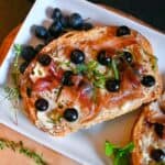 blueberry toast with prosciutto and goat cheese and herbs