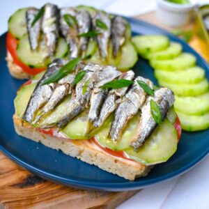 sardine sandwich with canned sardines cucumbers tomatoes and sourdough bread