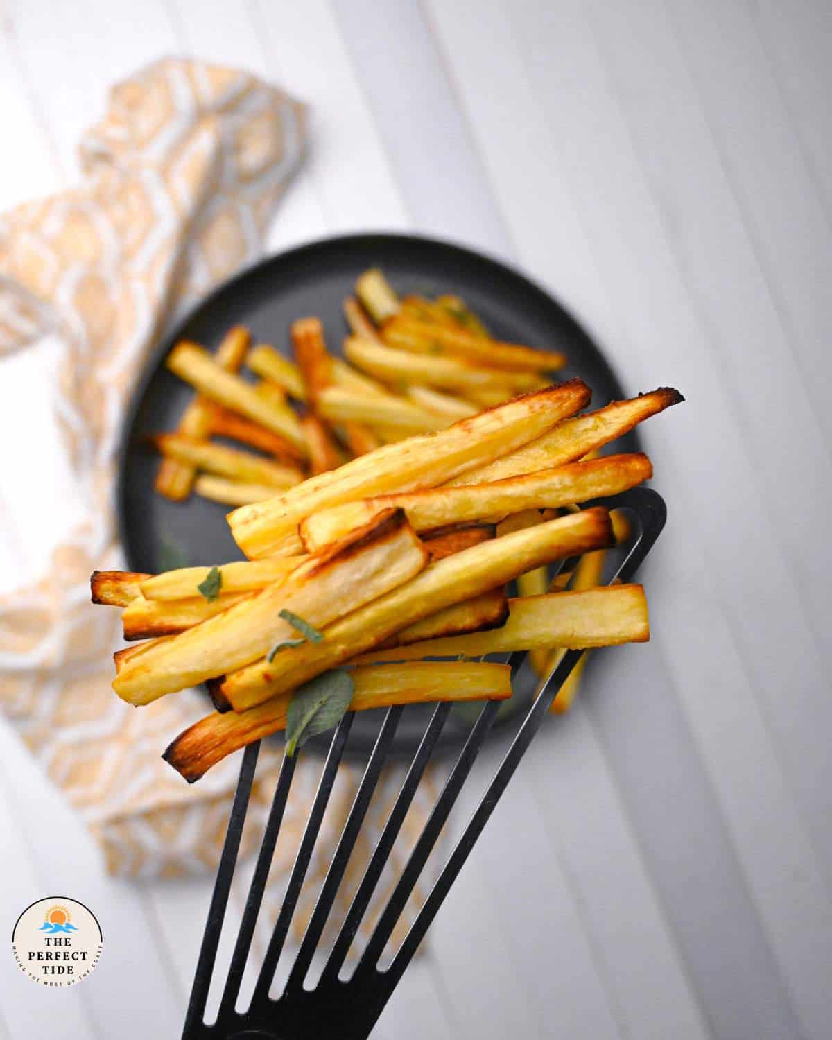 air fried parsnips fries on a spatula