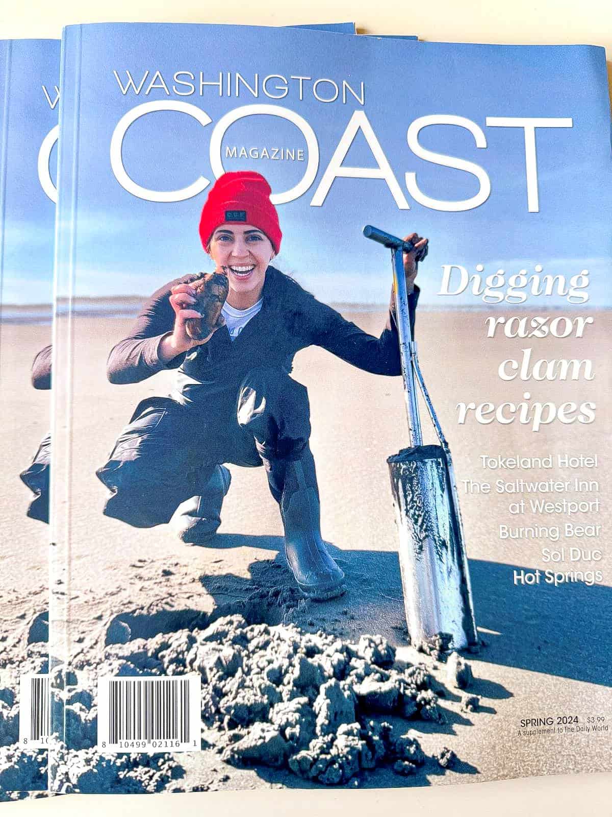 the perfect tide holding a razor clam and a clam gun on magazine