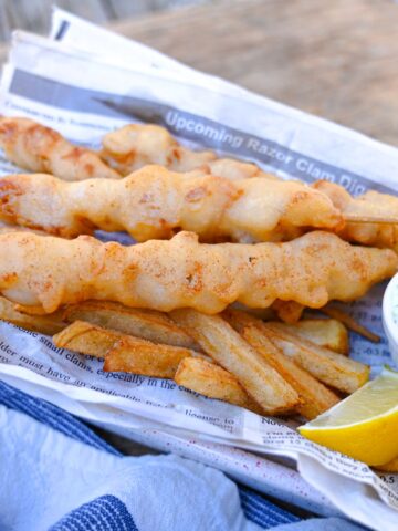 crispy fried razor clam recipe in a razor clam newspaper with fried lemon and tartar sauce