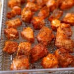 Golden crispy air fried salmon bites on a wire rack, ready to serve.