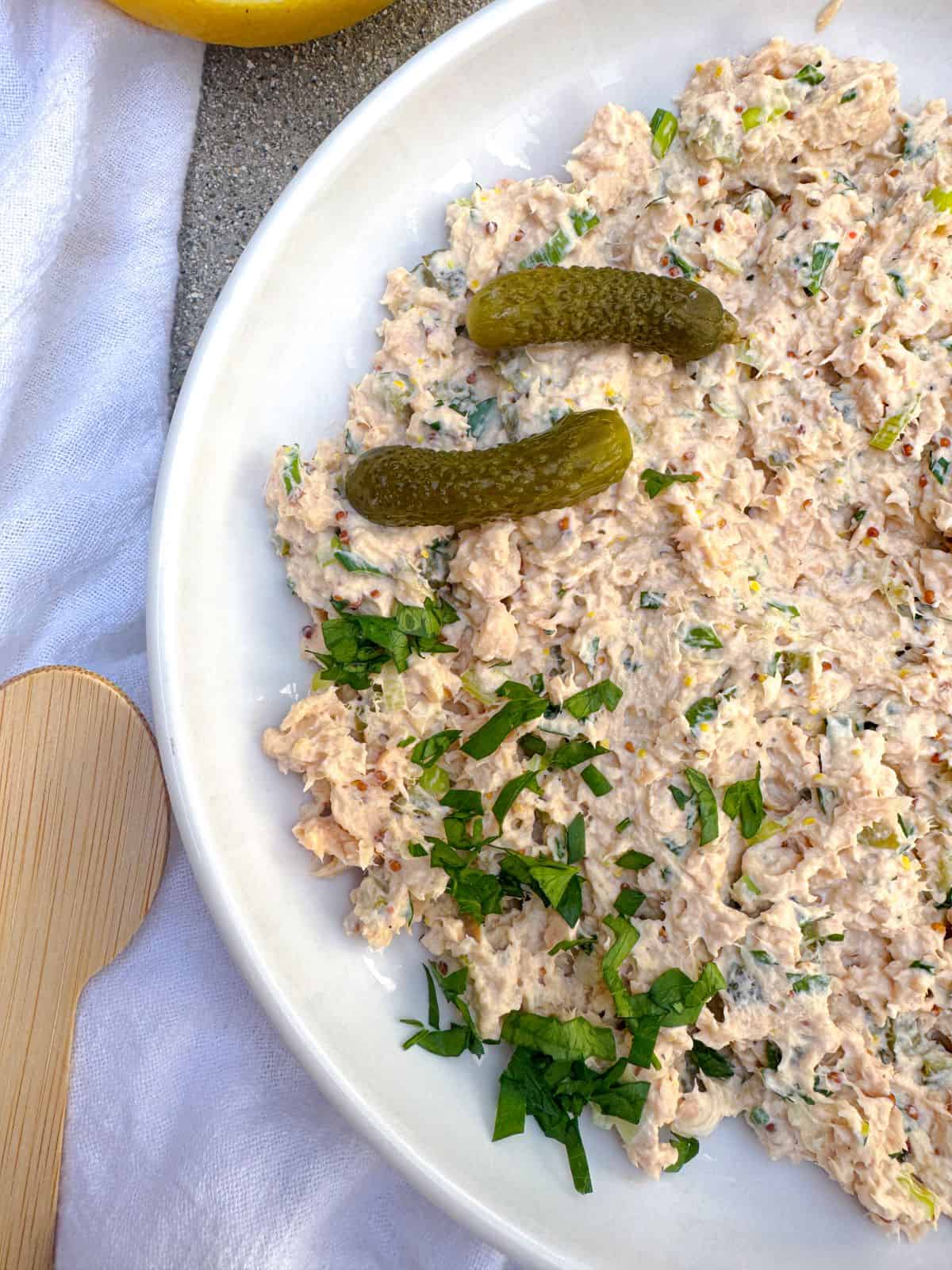 canned salmon salad recipe with pickles on a white plate