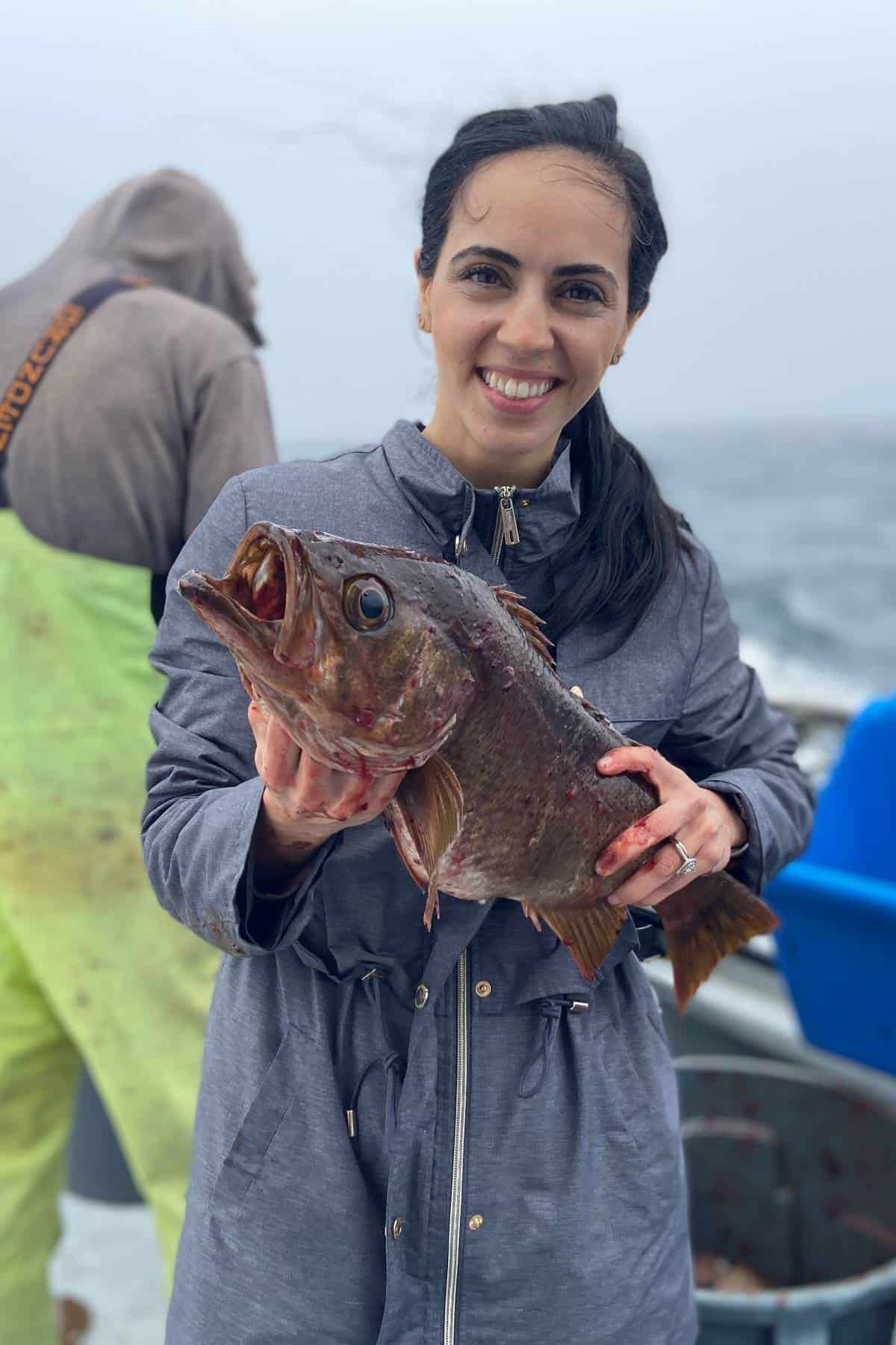 lady holding fish in a deep sea fishing charter for list on what to bring on deep sea charter